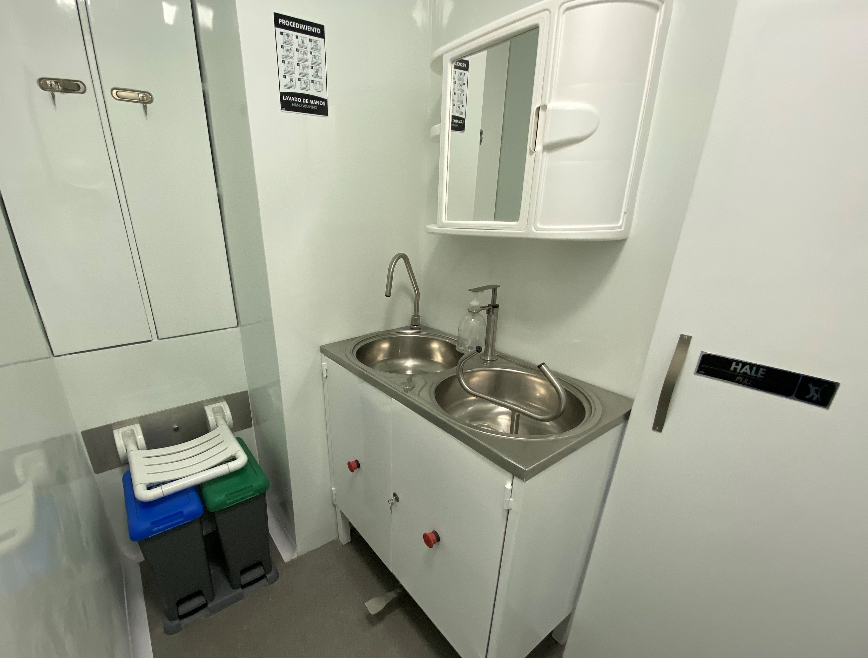 Biosafe zone detail: the combination of biological hazard signage, hazardous waste container, and sample transfer window defines the rigor of a Class 2 molecular diagnostic laboratory.