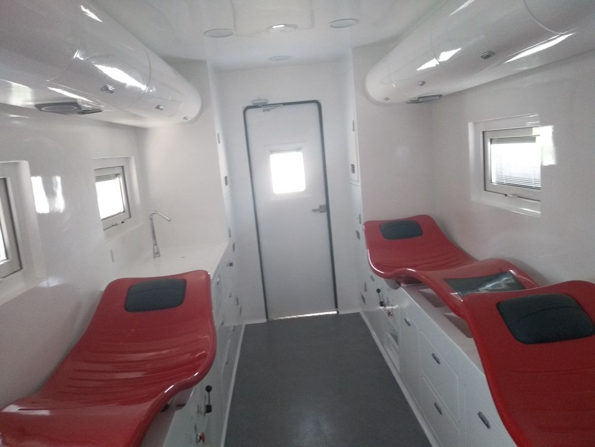 Panoramic view of the donation stations: ergonomic biomedical chairs on both sides of the central corridor